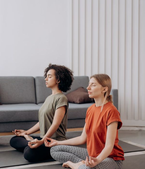 Woman in a serene prenatal yoga pose in a bright room.